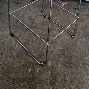Modern white bar stool with steel frame, perfect for contemporary kitchen or bar areas.