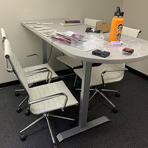 Modern HAT Electric 6x30 conference table with chairs in office setting.