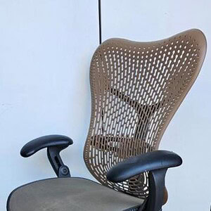 Herman Miller Mirra Nude ergonomic office chair with mesh back and adjustable features.