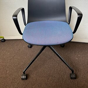 Black and blue guest or conference chair with armrests and rolling base.