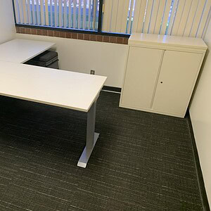 Electric height adjustable desk with cabinet for ergonomic workspace solutions. Perfect for offices.
