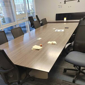 Berco 12-foot slate conference table with powered outlets for office meetings.