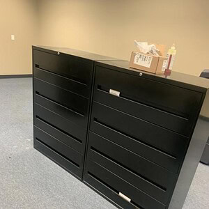 Black 36-inch four-drawer lateral file cabinet for office storage.
