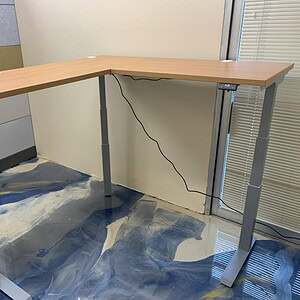 Shaped standing desk for ergonomic workspace comfort.