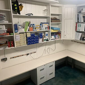 Office workspace with Herman Miller and Friant wrap-around desks, organized shelves, and storage sol.