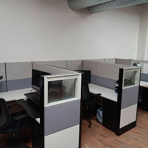 Office cubicles with privacy panels in a modern workspace.