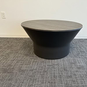 Modern driftwood round occasional table with black base, 32x16.5 inches.