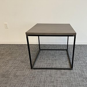 Square table with a grey top and black metal frame, ideal for modern office or home use.