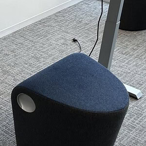 Slate grey Hightower gimbal ottoman for modern living spaces.