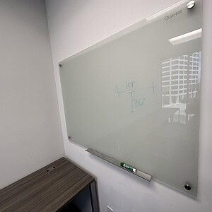 Whiteboard with glass surface for office and classroom use.
