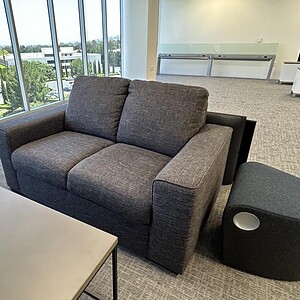 Medium Grey Living Spaces Love Seat for Modern Comfort.