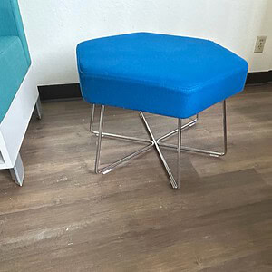 Blue Hexagon Ottoman with Wire Base for Modern Interior Decor.