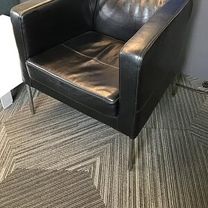 Black Leather Compel Club Chair with Steel Base for Modern Office Decor.