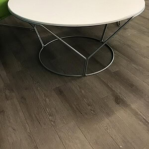 White round Keilhauer occasional table with wired metal base for versatile office or lounge use.
