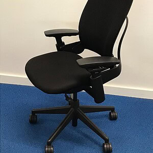 Black ergonomic office chair with adjustable features for comfort.