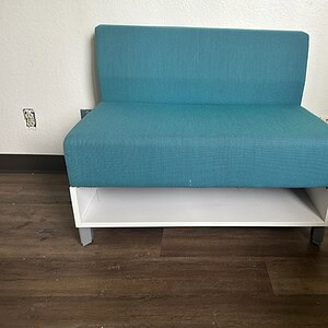 Allsteel teal modular seating with built-in shelf, ideal for modern office or lounge spaces.
