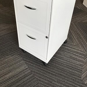 White mobile file pedestal with chrome handles, ideal for office storage solutions.
