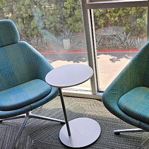 Teal lounge chairs with side table, perfect for office or lounge spaces.