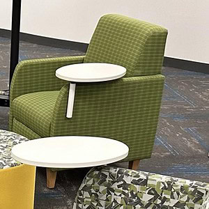 Green lounge chair with attached tablet arm, perfect for modern office or lounge spaces.