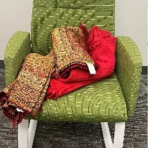 Green rocking chair with white steel base, upholstered in textured fabric. Perfect for modern living.