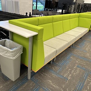 Modern OFS green high back modular seating with bar top in commercial space.