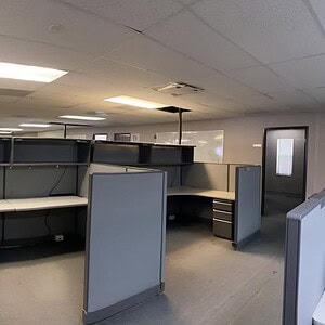 Haworth Unigroup adjustable grey office desk in a modern workspace.
