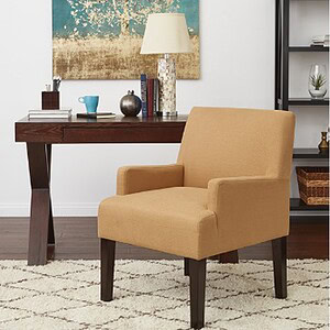 Comfortable beige guest chair with wooden legs in stylish home or office setting.