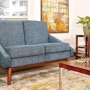 Inspired blue loveseat for modern living spaces. Perfect for cozy, stylish seating in your home.