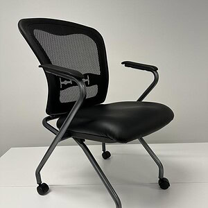 OFS nesting chair featuring a breathable mesh back and comfortable vinyl seat, ideal for modern offi.