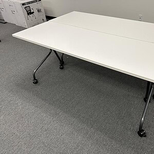 White mobile conference table for meetings and collaborative workspaces.
