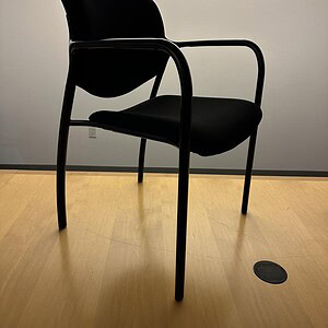 Black guest chair for office or reception areas.