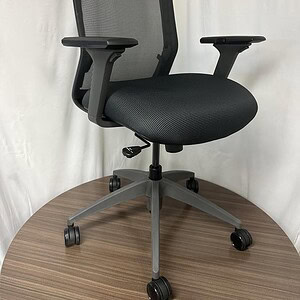 Ergonomic grey and black office chair with mesh back and adjustable features.
