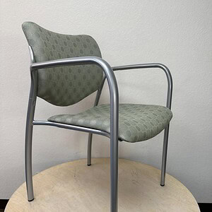 Herman Miller Sage Green Guest Chair with metal frame and cushioned seat and backrest. Perfect for o.