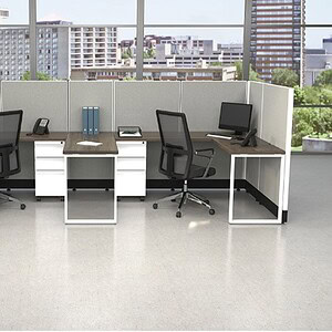 Shape shared workspace with modern desks and office chairs.