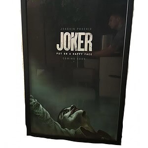 Joker framed movie poster, 27x40 inches, featuring Joaquin Phoenix's iconic character. Perfect for h.