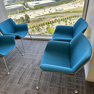 Bright blue Steelcase bucket seats for contemporary office spaces. Perfect for waiting areas or coll.