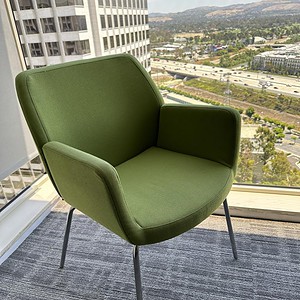 Lime green Coalesse Bindu side chair with modern design and metal legs. Perfect for office or lounge.