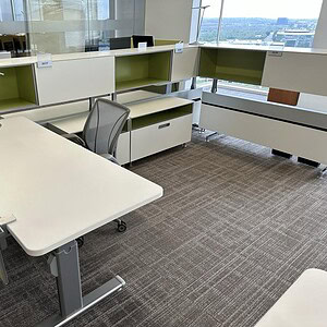 Modern office workspace with Steelcase Power Base and HAT tables in a bright, open environment.