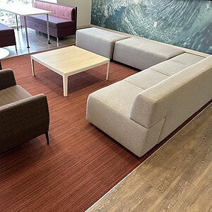 Modern Coalesse Ivory 7ft sofa with two matching ottomans in a stylish lounge setting.