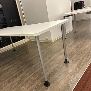 Modern Coalesse desk with white top and steel legs, ideal for office spaces.