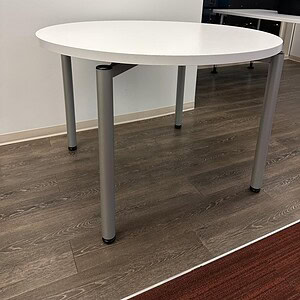 Modern 41-inch round white table by Steelcase, ideal for office or conference rooms.