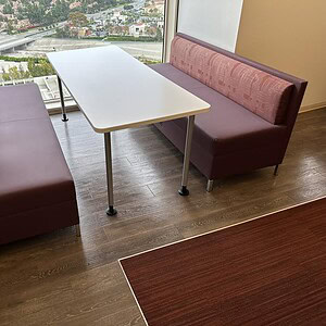 Comfortable lounge seating with a white table, ideal for modern office or hospitality spaces.