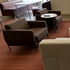 Modern red and black sofa lounge chairs in stylish office setting.