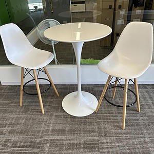 White Tulip table with two modern chairs, ideal for contemporary office or dining spaces.