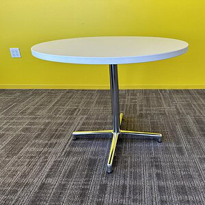 Modern white round table with chrome T base, 3-foot height, ideal for office or conference rooms.