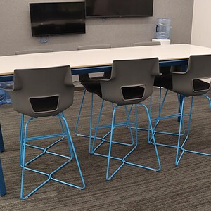 Steelcase Payback bar height table with modern chairs in a conference room setting.