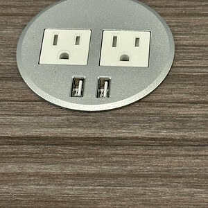 Power grommet with dual USB ports for convenient device charging. Perfect for office or workspace ca.