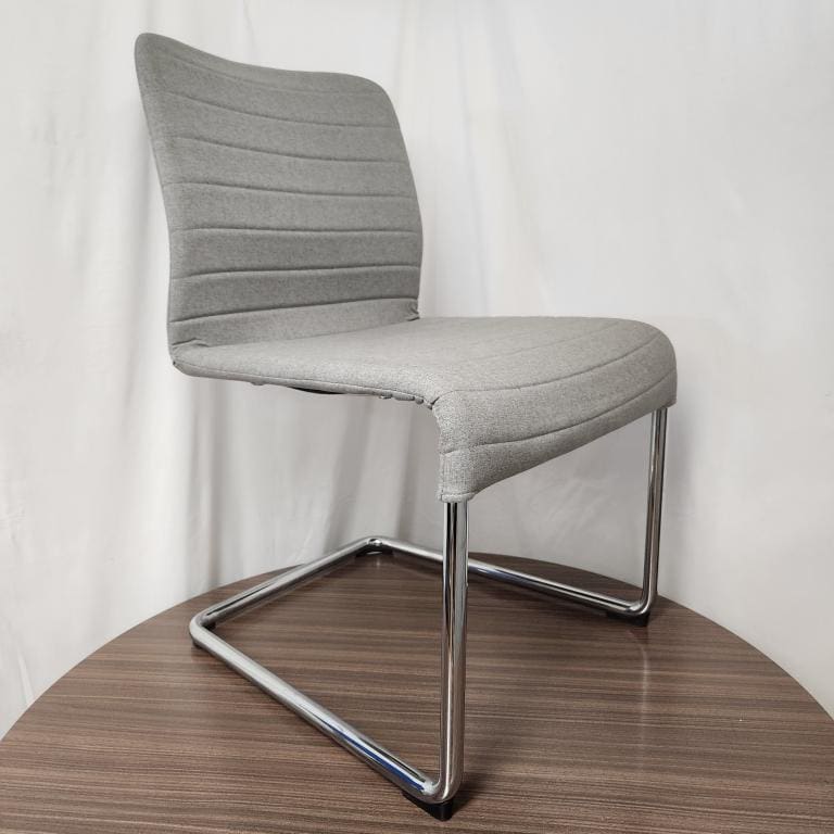 Stylish grey chair with chrome sled base, ideal for modern office or home decor.