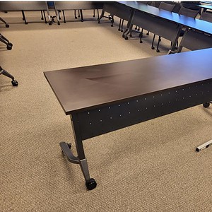 Nesting table in espresso finish, ideal for office or conference room setups, featuring a modesty pa.