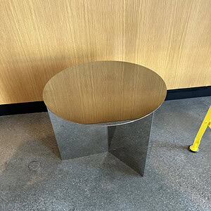 Round side table with mirror top and metal base, stylish home accent piece.